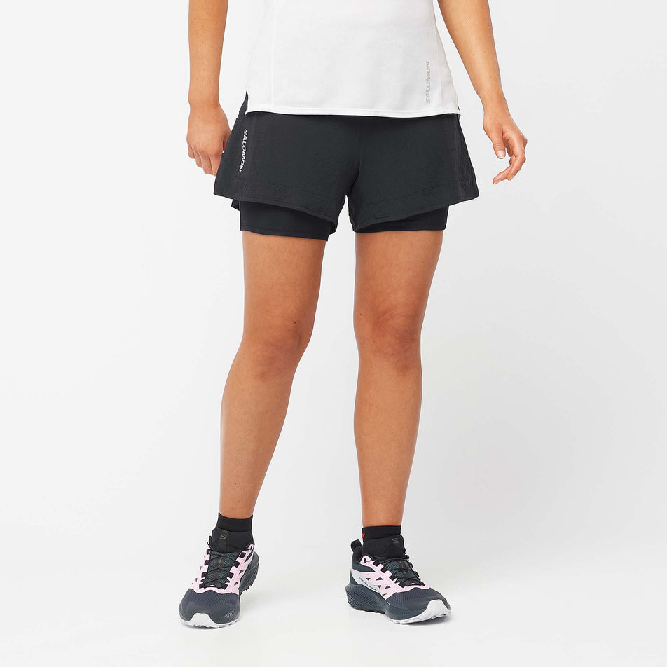 Front view of a model wearing a pair of Salomon Women's Sense 2in1 Shorts in the Deep Black colourway (8000776437922)