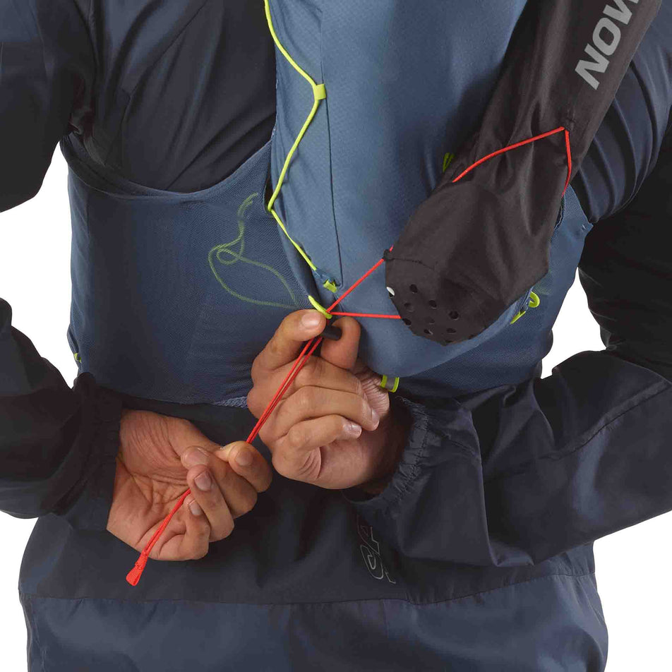 The Salomon Custom Quiver in the Black colourway attached to the back of a hydration vest.