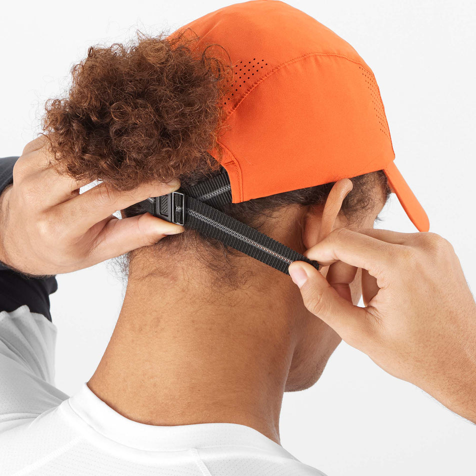 Back view of a model wearing a Salomon Unisex Cross Cap in the Burnt Ochre colourway (8008809480354)