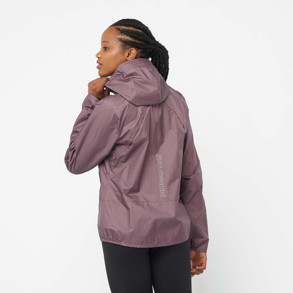 Back view of a model wearing a Salomon Women's Bonatti Waterproof Jacket in the Moonscape colourway (7999026266274)