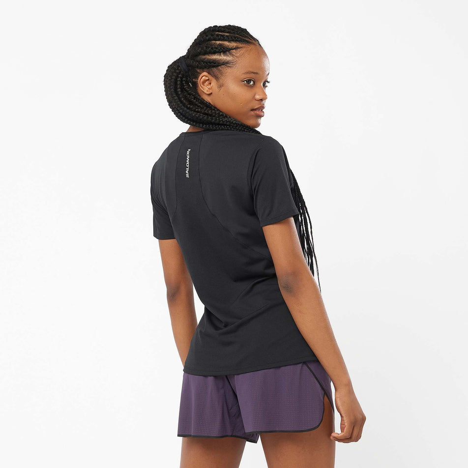 Back view of a model wearing a Salomon Women's Sense Aero Short Sleeve T-Shirt in the Deep Black colourway (8000768901282)