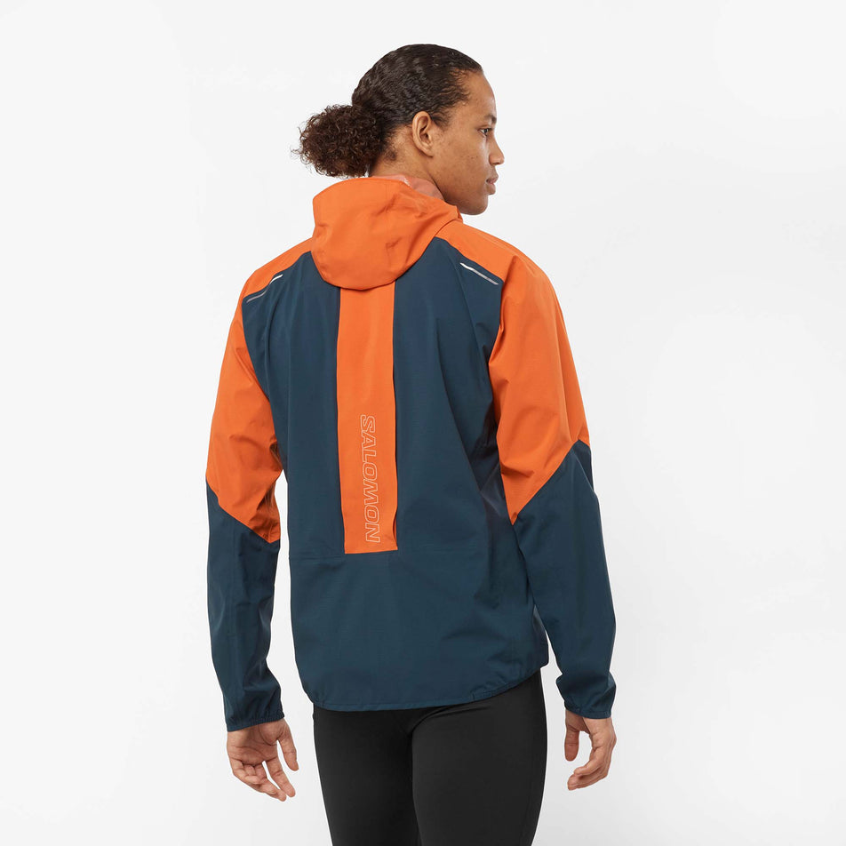 Back view of a model wearing a Salomon Men's Bonatti Trail Jacket in the Burnt Ochre/Carbon colourway (8008561098914)