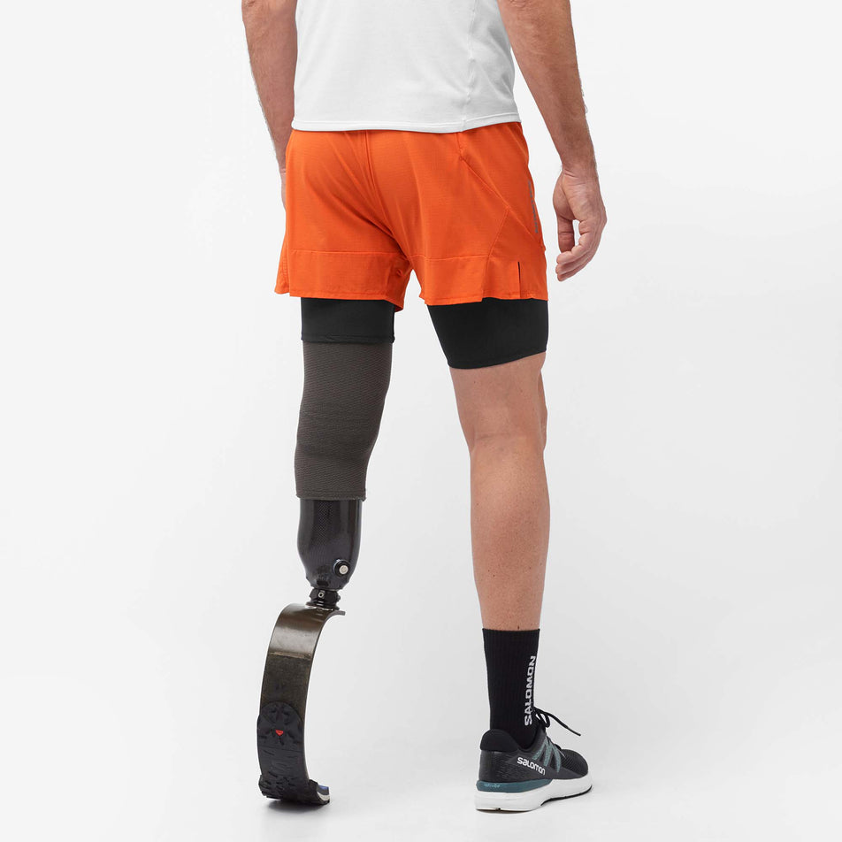 Back view of a model wearing a pair of Salomon Men's Sense Aero 2in1 Shorts in the Burnt Ochre colourway (8008583315618)