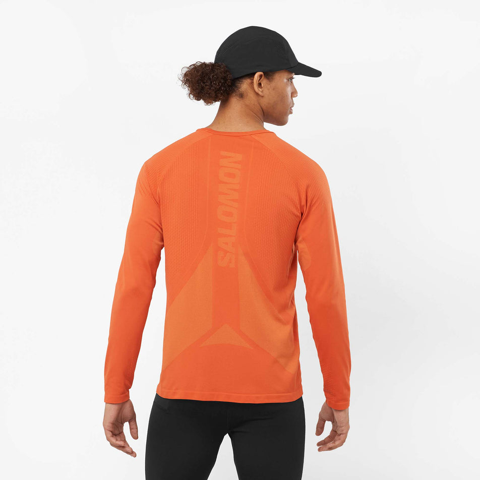 Back view of a model wearing a Salomon Men's Sense Aero Long Sleeve T-Shirt in the Burnt Ochre colourway (8008567488674)