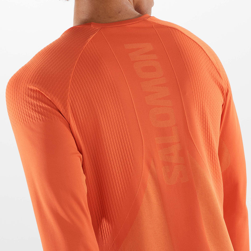 Close-up back view of a model wearing a Salomon Men's Sense Aero Long Sleeve T-Shirt in the Burnt Ochre colourway (8008567488674)
