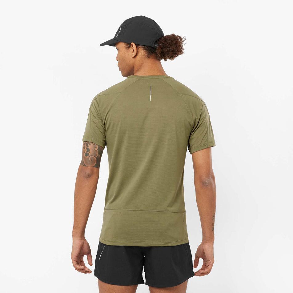 Back view of a model wearing a Salomon Men's Cross Run Short Sleeve T-Shirt in the Deep Lichen Green colourway (8008547041442)