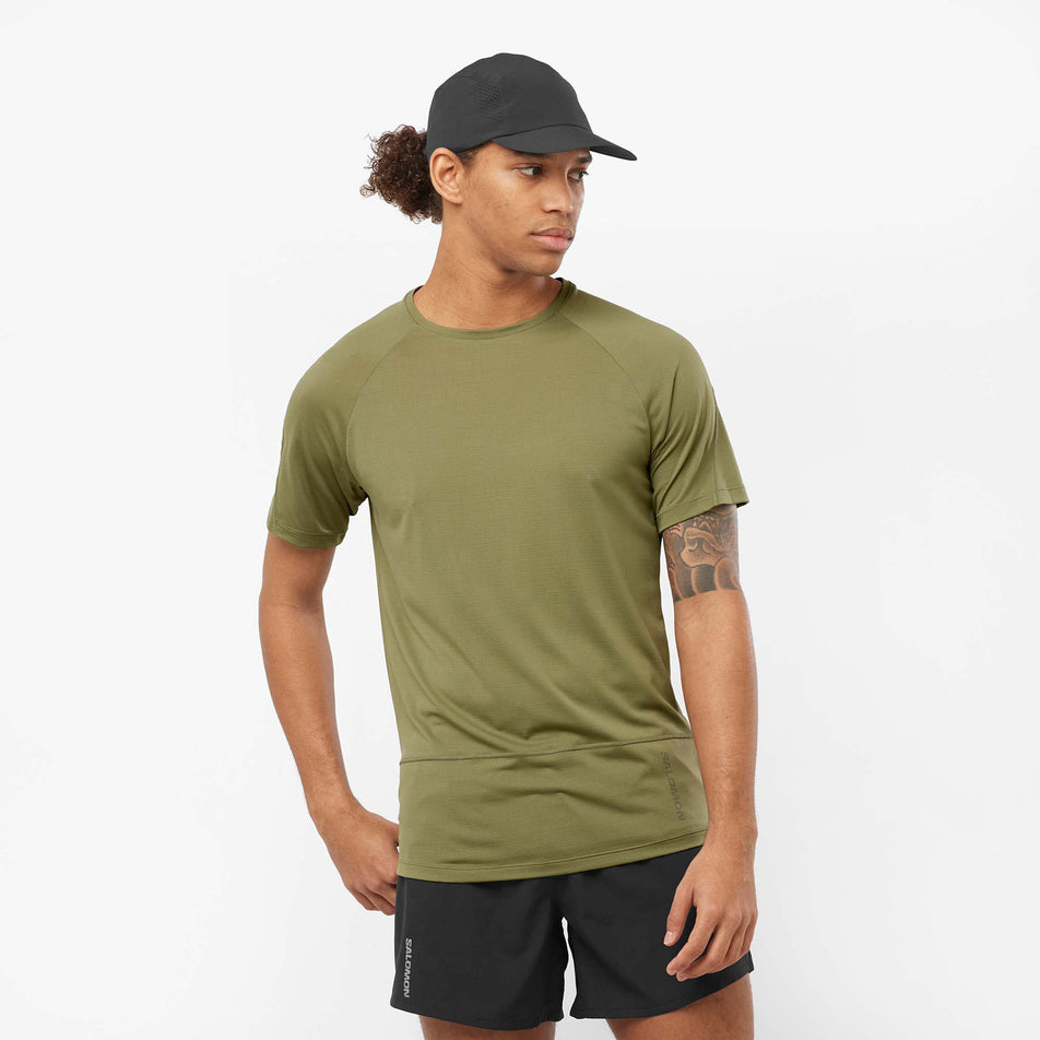 Front view of a model wearing a Salomon Men's Cross Run Short Sleeve T-Shirt in the Deep Lichen Green colourway (8008547041442)