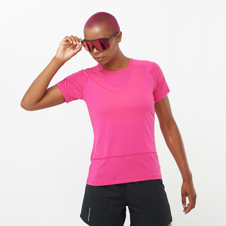 Front view of a model wearing a Salomon Women's Cross Run Short Sleeve T-Shirt in the Beetroot Purple colourway. Model is also wearing Salomon running shorts. (8157877502114)