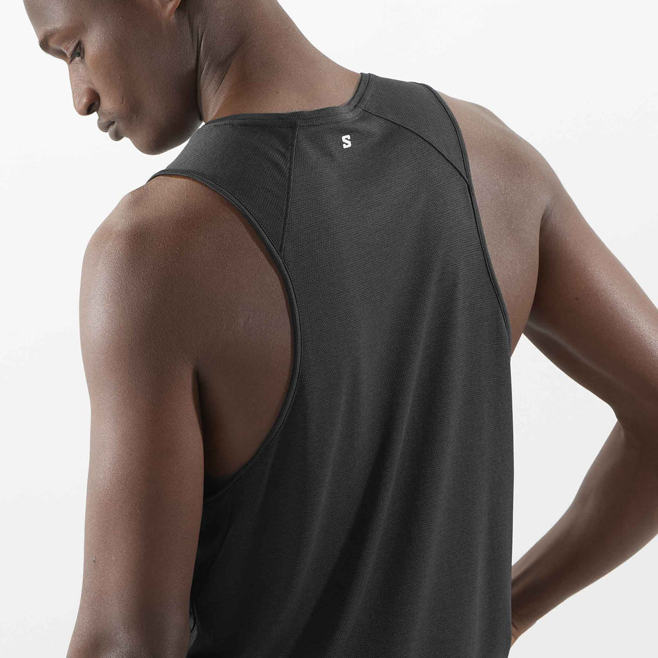 Back view of a model wearing the Salomon Men's Shakeout Core Tank in the Deep Black colourway. 