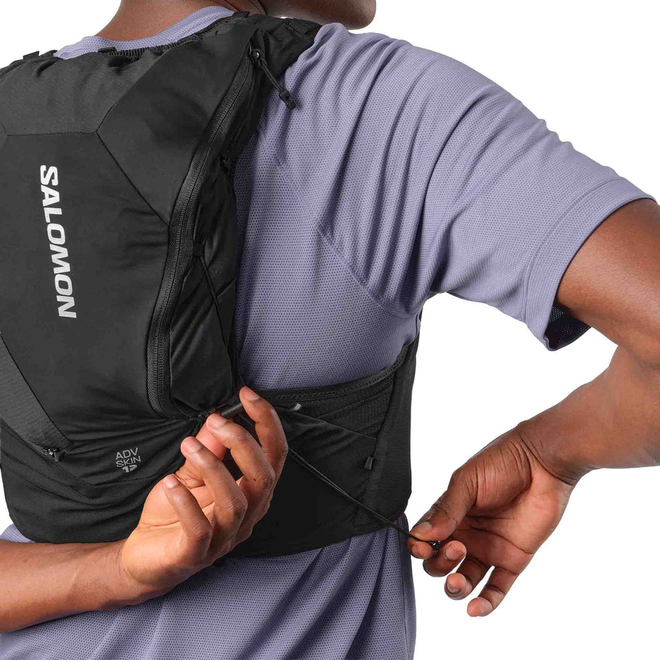 Back view of a model wearing the Salomon Unisex ADV Skin 12 Running Vest in the Black colourway.