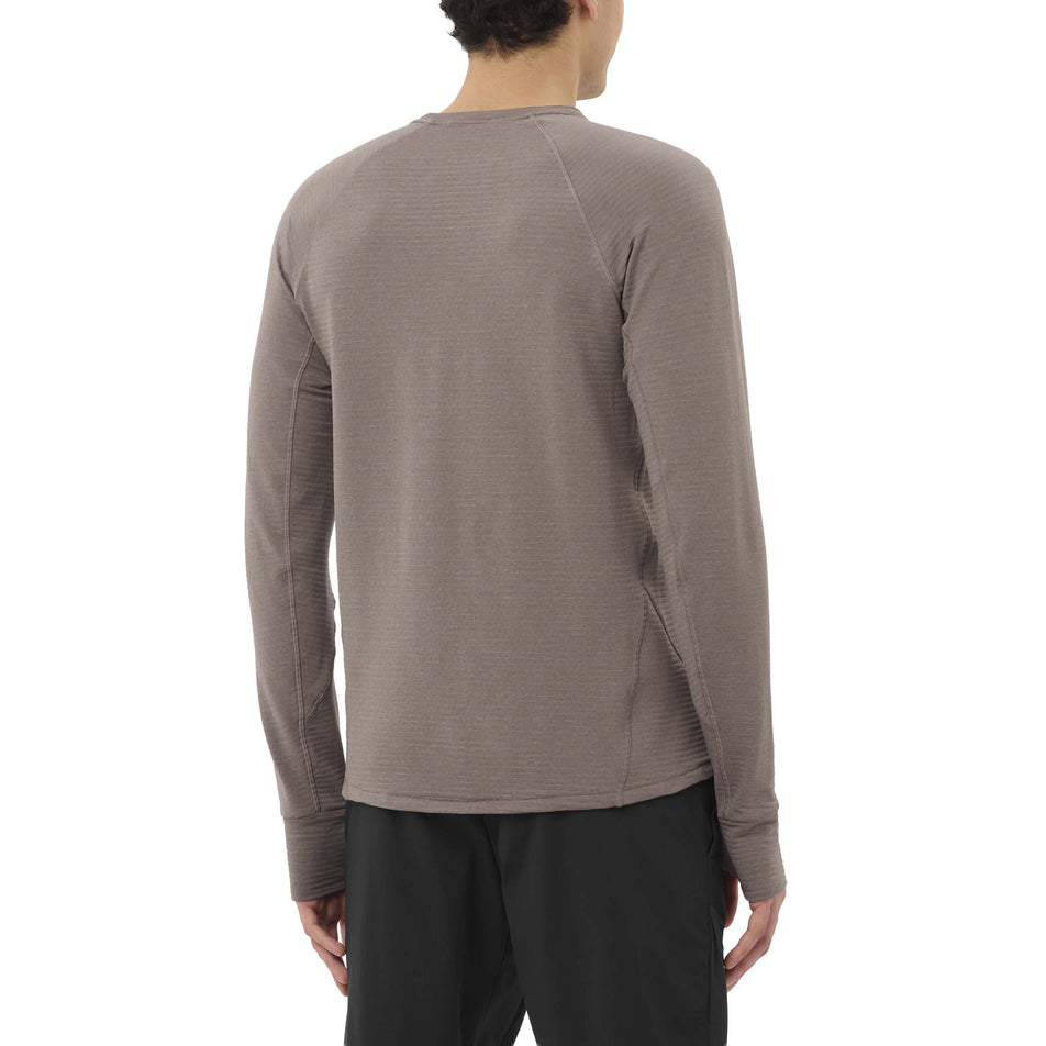 Back view of a model wearing the Salomon Men's Essential Lightwarm Crewneck Pullover in the Iron colourway. (8736775143586)