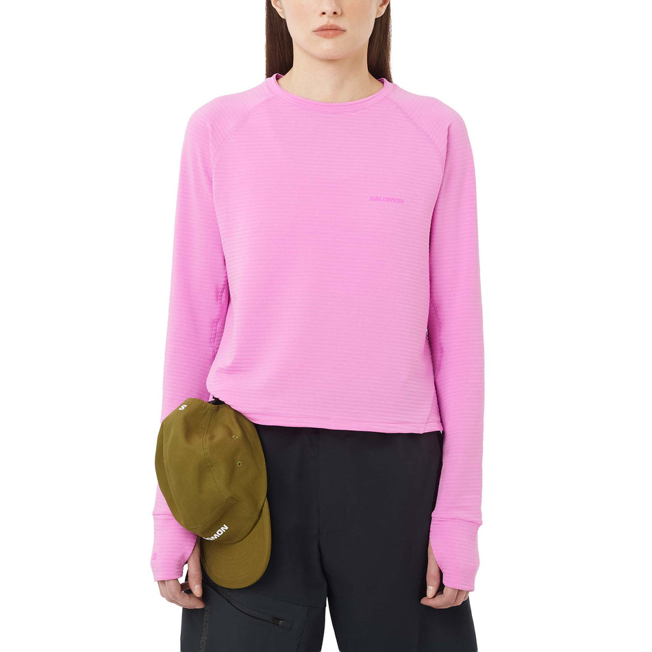 Front view of a model wearing the Salomon Women's Essential Lightwarm Long-Sleeve Baselayer in the Cyclamen colourway. (8726946578594)