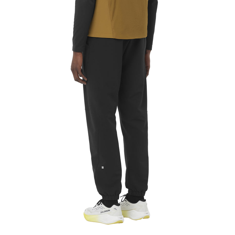 Back view of a model wearing the Salomon Men's SHAKEout HexaFlow Pants in the Deep Black colourway. (8781939835042)
