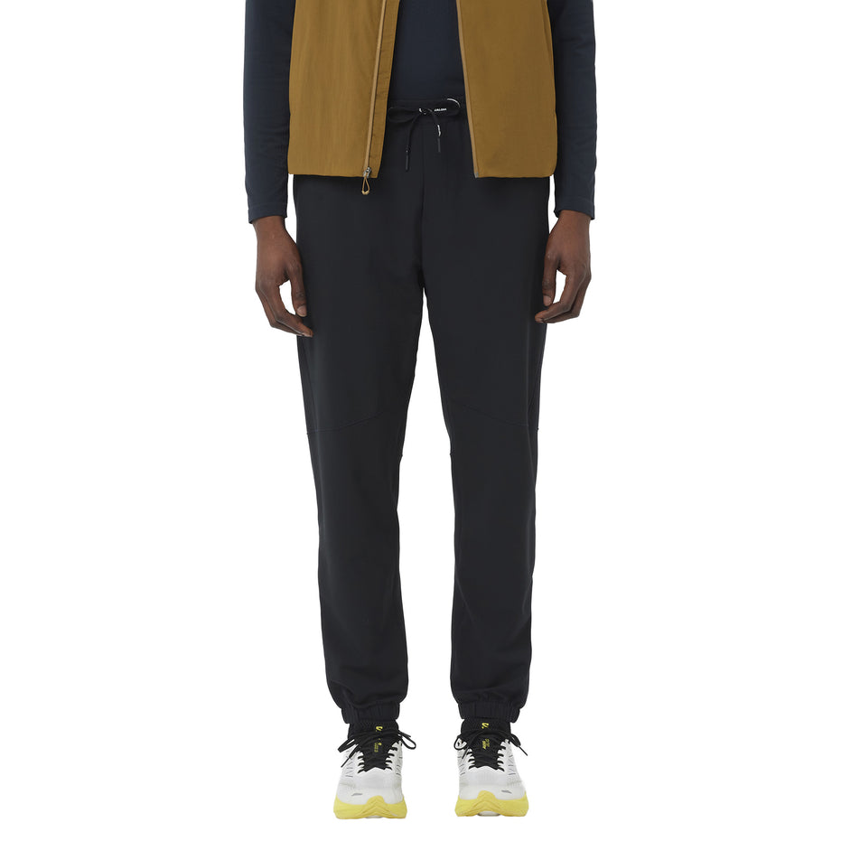 Front view of a model wearing the Salomon Men's SHAKEout HexaFlow Pants in the Deep Black colourway.(8781939835042)