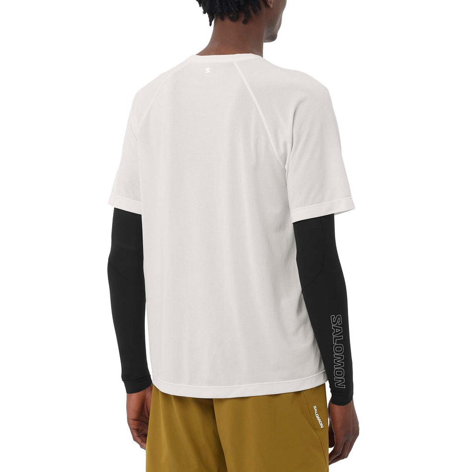 Back view of a model wearing the Salomon Men's SHKout Core SS Tee in the Whisper White colourway.