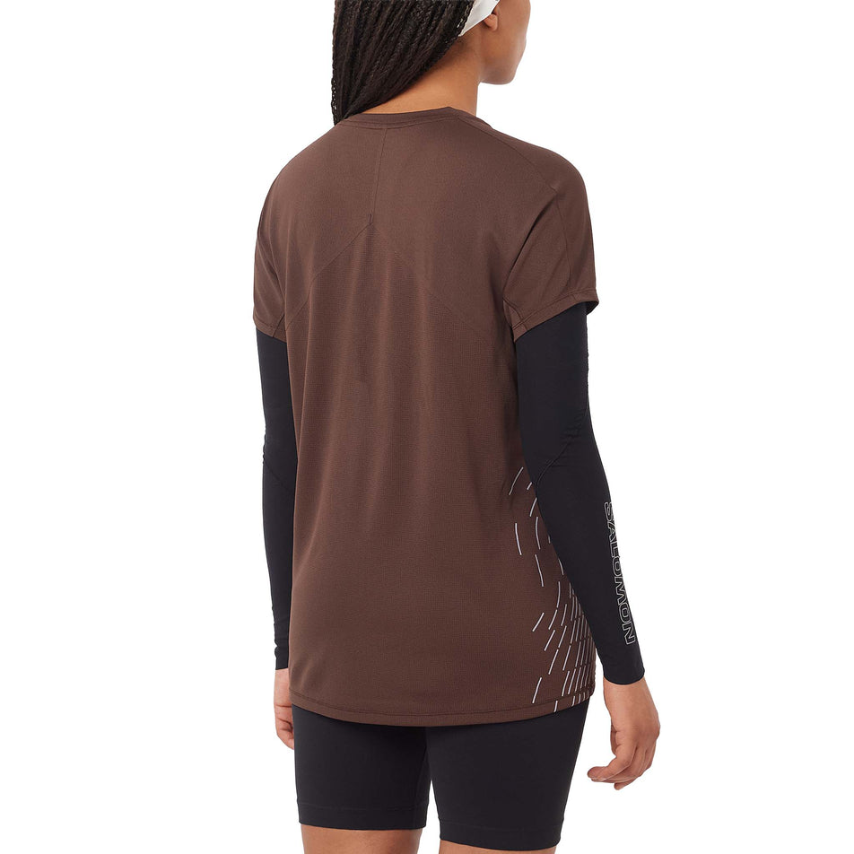 Back view of a model wearing the Salomon Women's Sense Aero Graphic Short Sleeve T-Shirt in the Coffee Bean/Cosmic Sky colourway. (8727022796962)