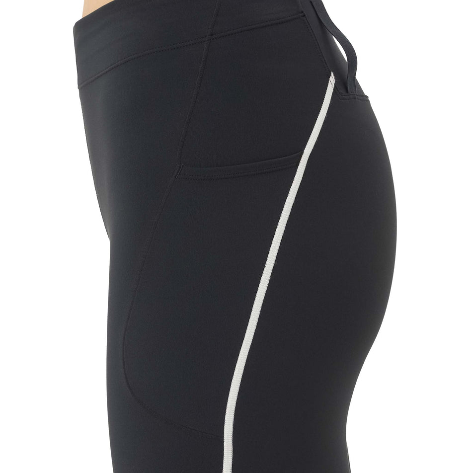 Side view of a model wearing the Salomon Women's Sense Stow Short Tights 6