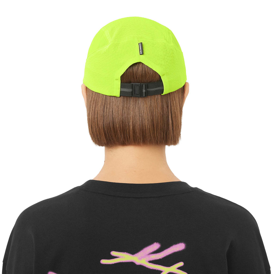 Back view of a model wearing the Salomon Unisex Sense Aero Cap in the Acid Lime colourway.