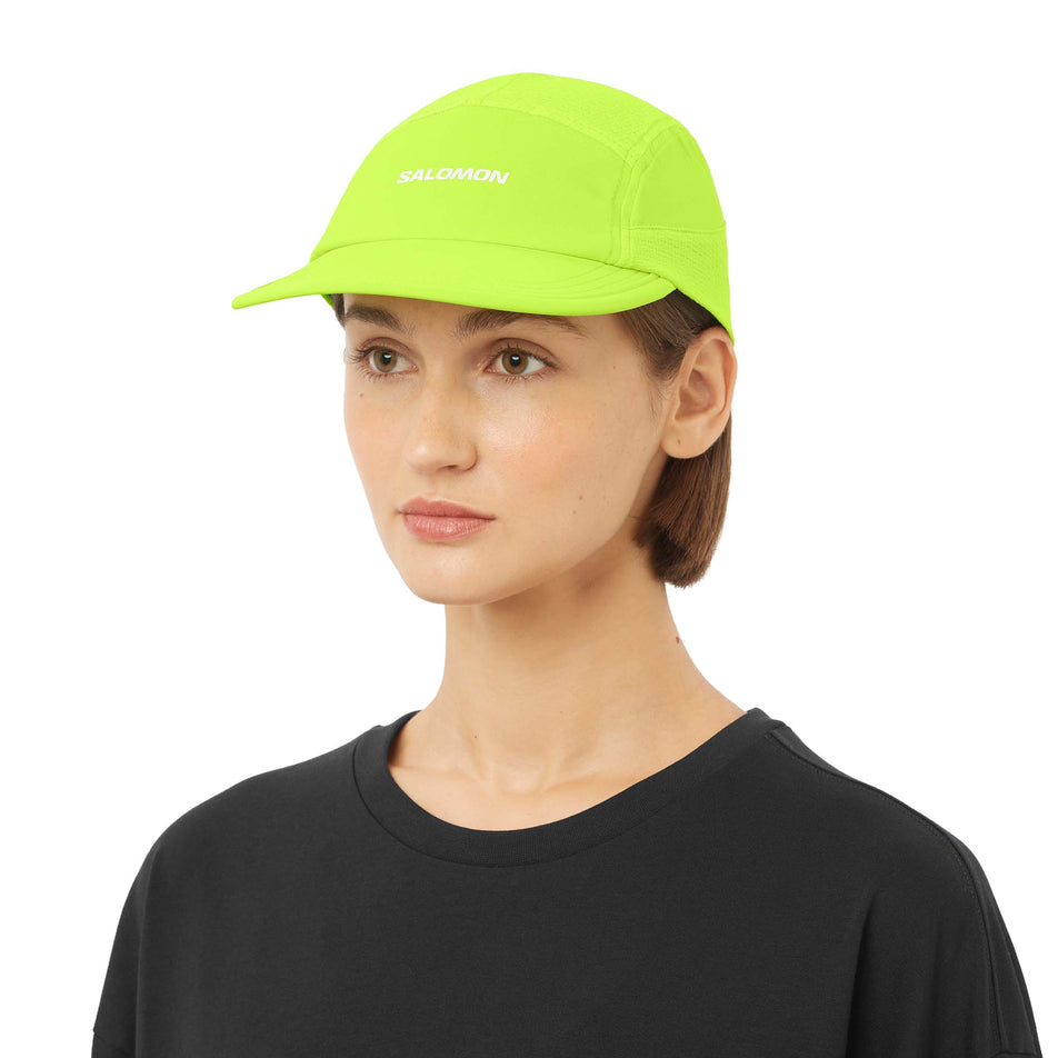Front view of a model wearing the Salomon Unisex Sense Aero Cap in the Acid Lime colourway.