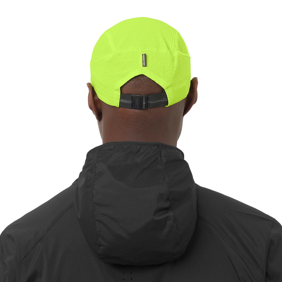 Back view of a model wearing the Salomon Unisex Sense Aero Cap in the Acid Lime colourway.
