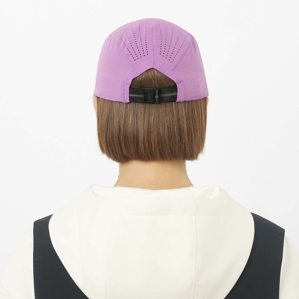 Back view of a model wearing the Salomon Unisex Shakeout Cap in the Iris Orchid colourway.