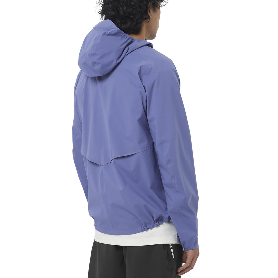 Back view of a model wearing the Salomon Men's Bonatti Waterproof Shell Jacket in the Marlin colourway.
