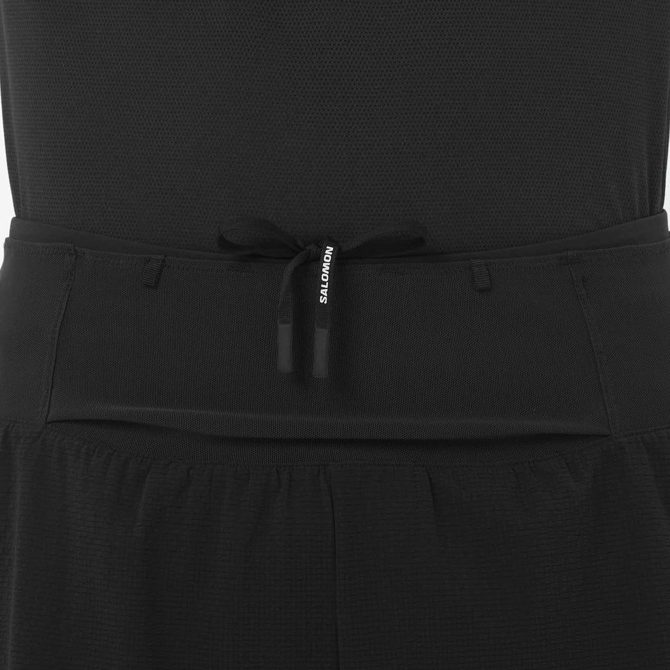 Front view of a model wearing the Salomon Men's Sense Aero 2in1 Trail Shorts 5