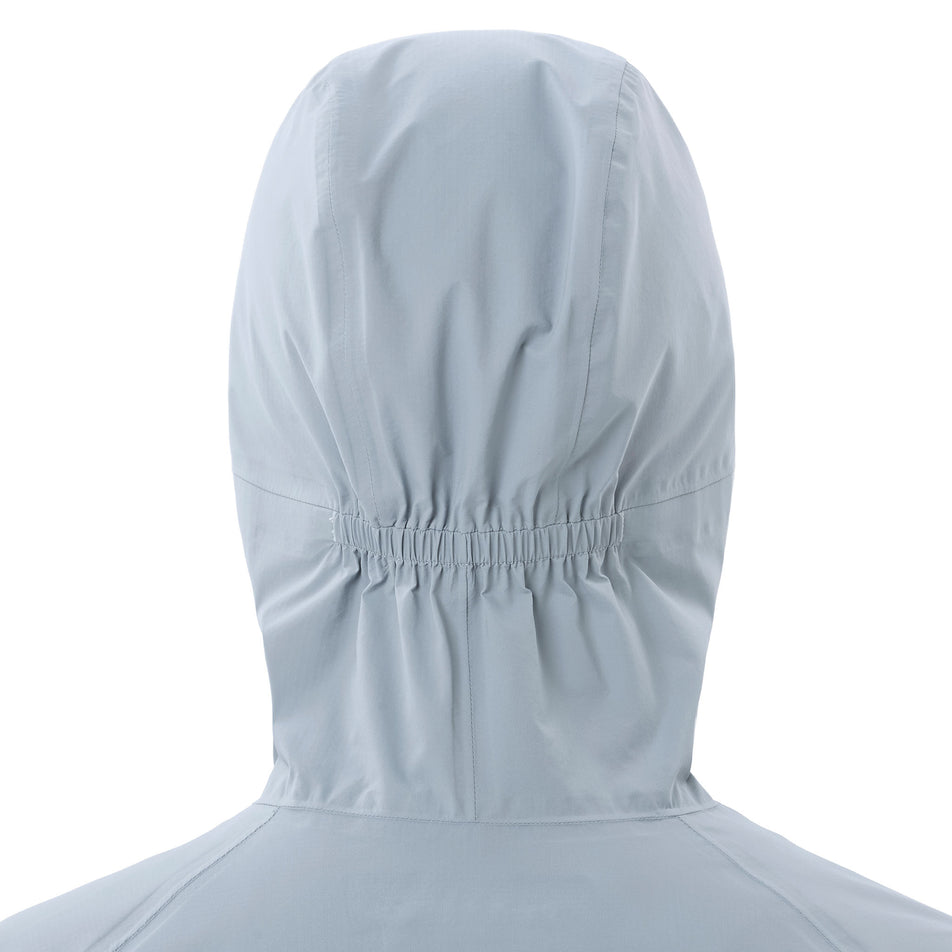 Back view of a model wearing the Salomon Women's Bonatti Waterproof Jacket in the Trade Winds colourway.