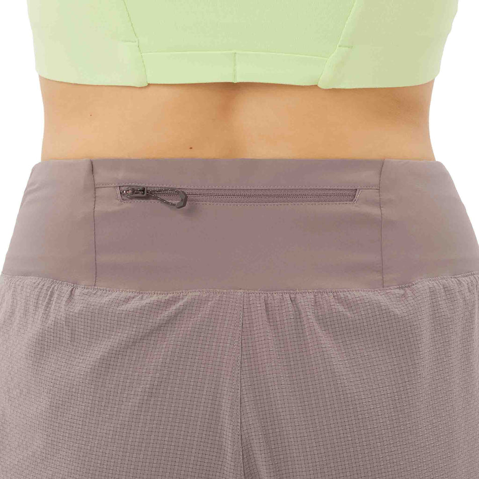Back view of a model wearing the Salomon Women's Sense Aero Stow 4