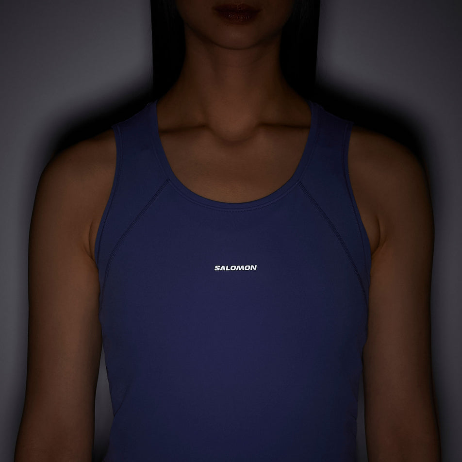 Front view of a model wearing the Salomon Women's SHKout Bliss Tanklette in the Marlin colourway.