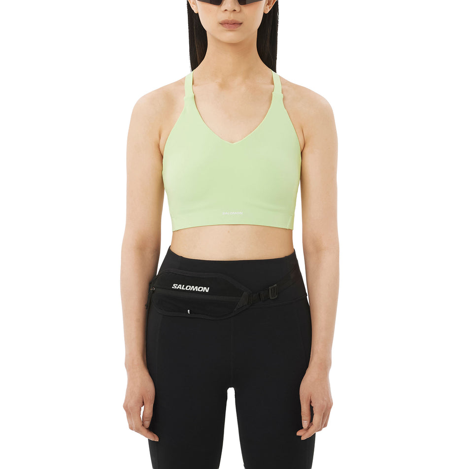 Front view of a model wearing the Salomon Women's SHKout Bliss Bra in the Butterfly colourway.