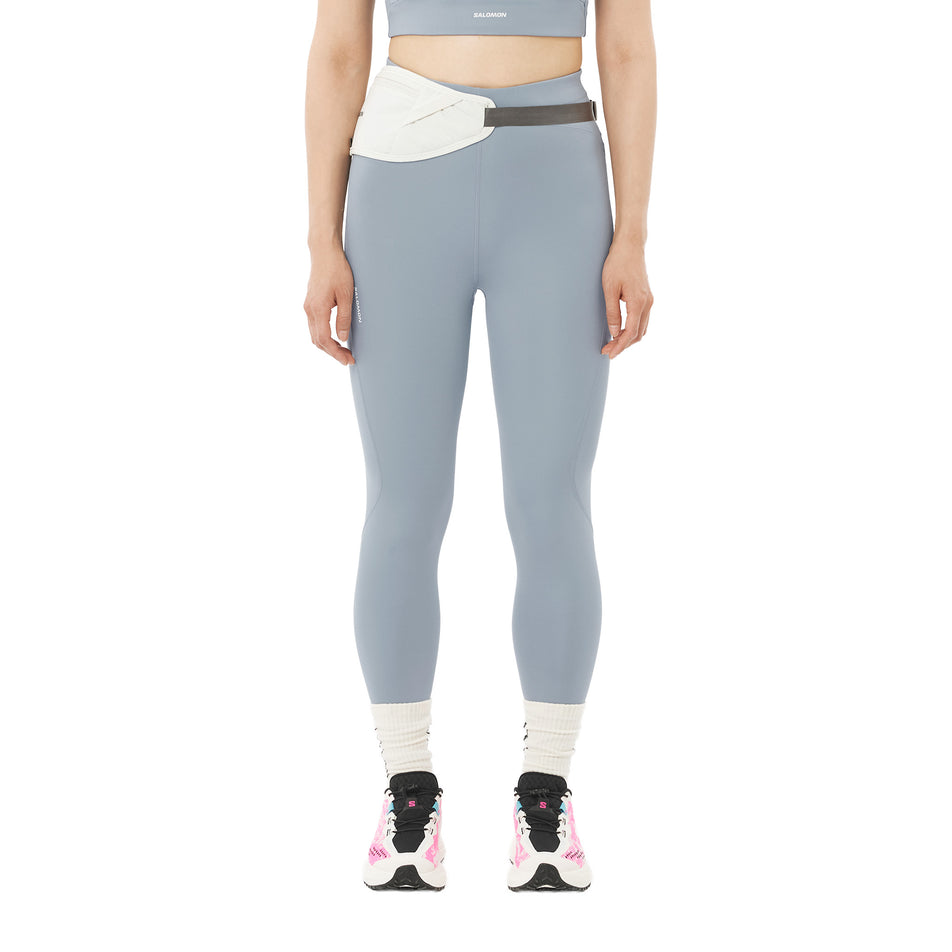 Front view of a model wearing the Salomon Women's SHKout Core Tights in the Trade Winds colourway.