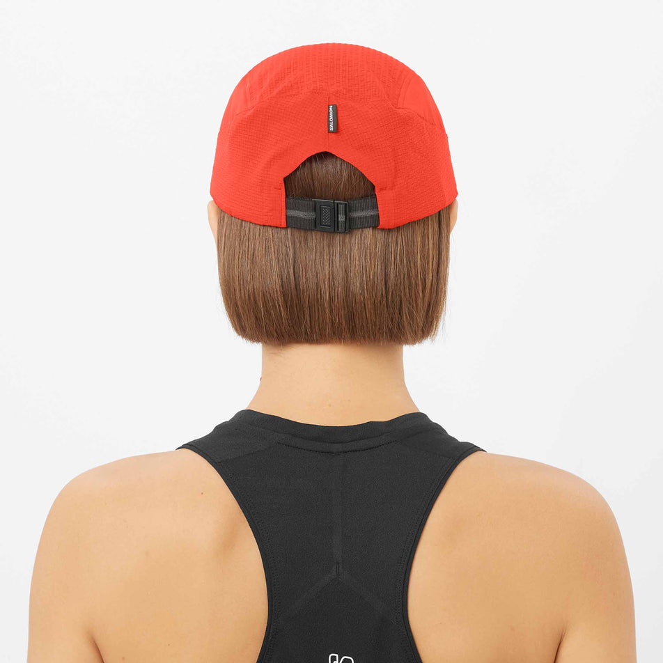 Back view of a model wearing the Salomon Unisex Sense Aero Cap in the Fiery Red colourway.