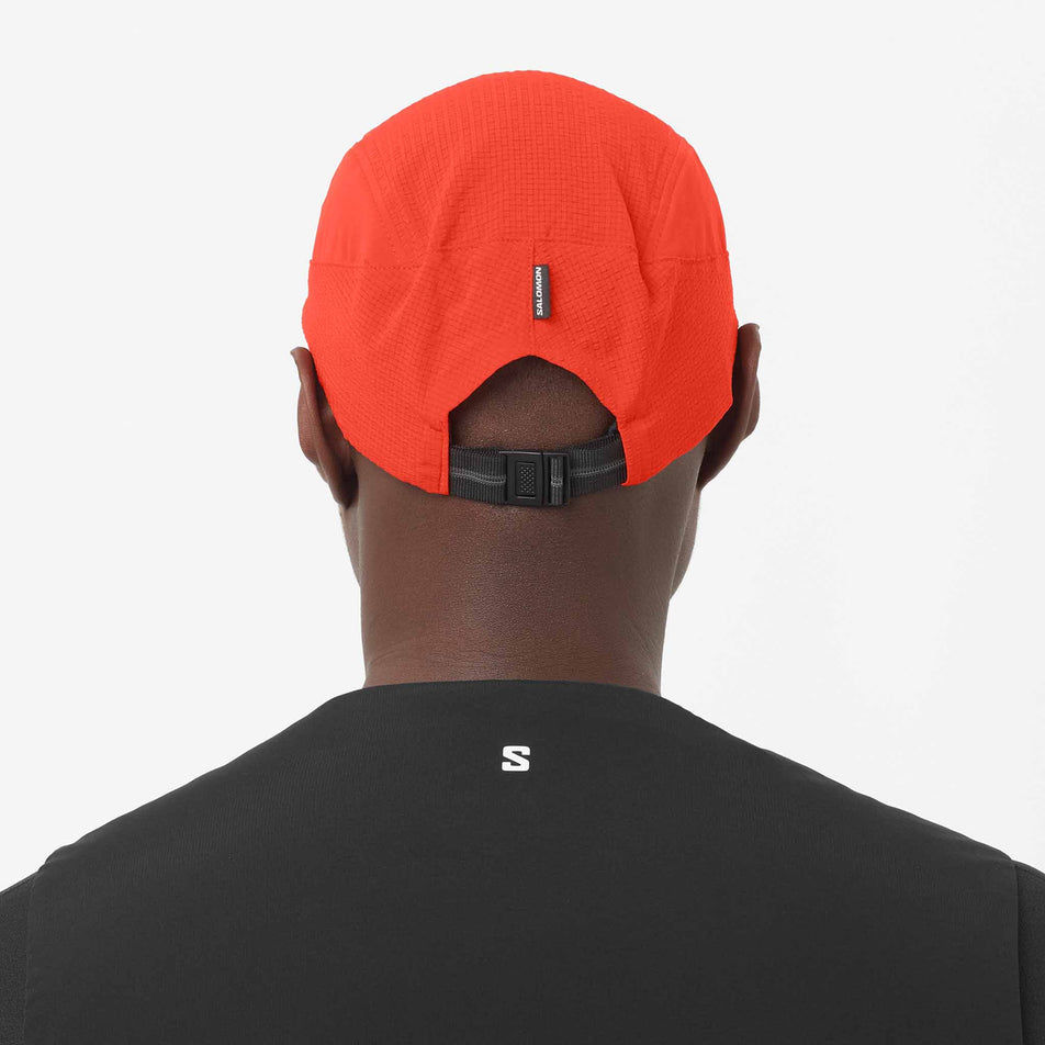 Back view of a model wearing the Salomon Unisex Sense Aero Cap in the Fiery Red colourway.