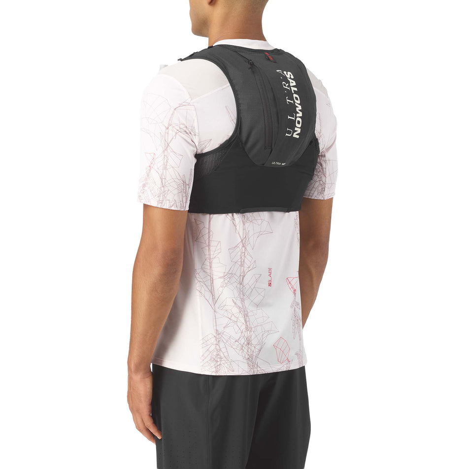 Back view of a model wearing the Salomon Unisex S/LAB Ultra 12 Running Vest in the Black colourway.
