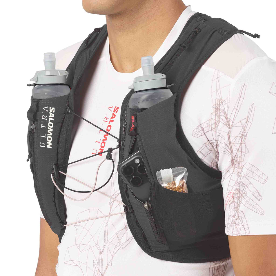 Angled view of a model wearing the Salomon Unisex S/LAB Ultra 12 Running Vest in the Black colourway.