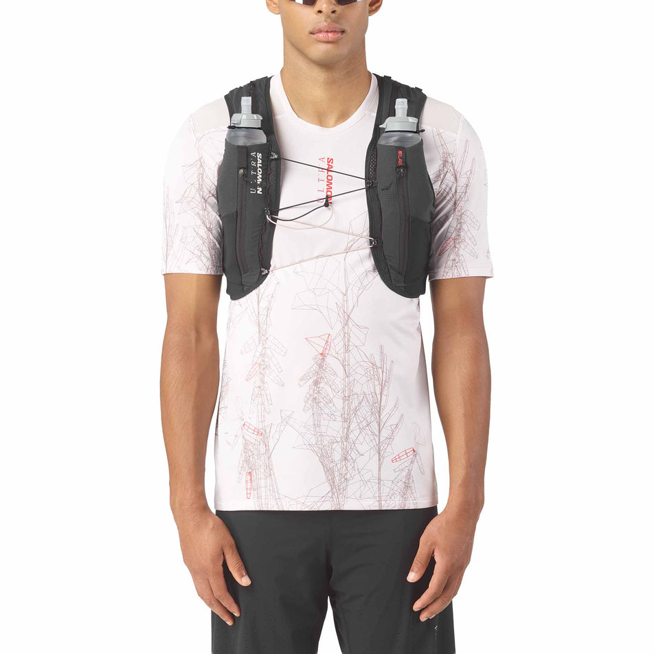 Front view of a model wearing the Salomon Unisex S/LAB Ultra 12 Running Vest in the Black colourway.
