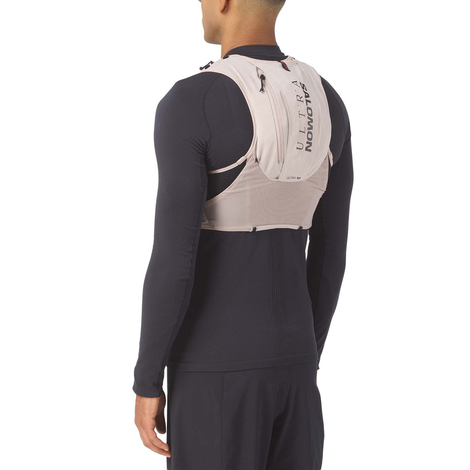 Back view of a model wearing the Salomon Unisex S/LAB Ultra 12 Running Vest in the Goat/Black colourway.