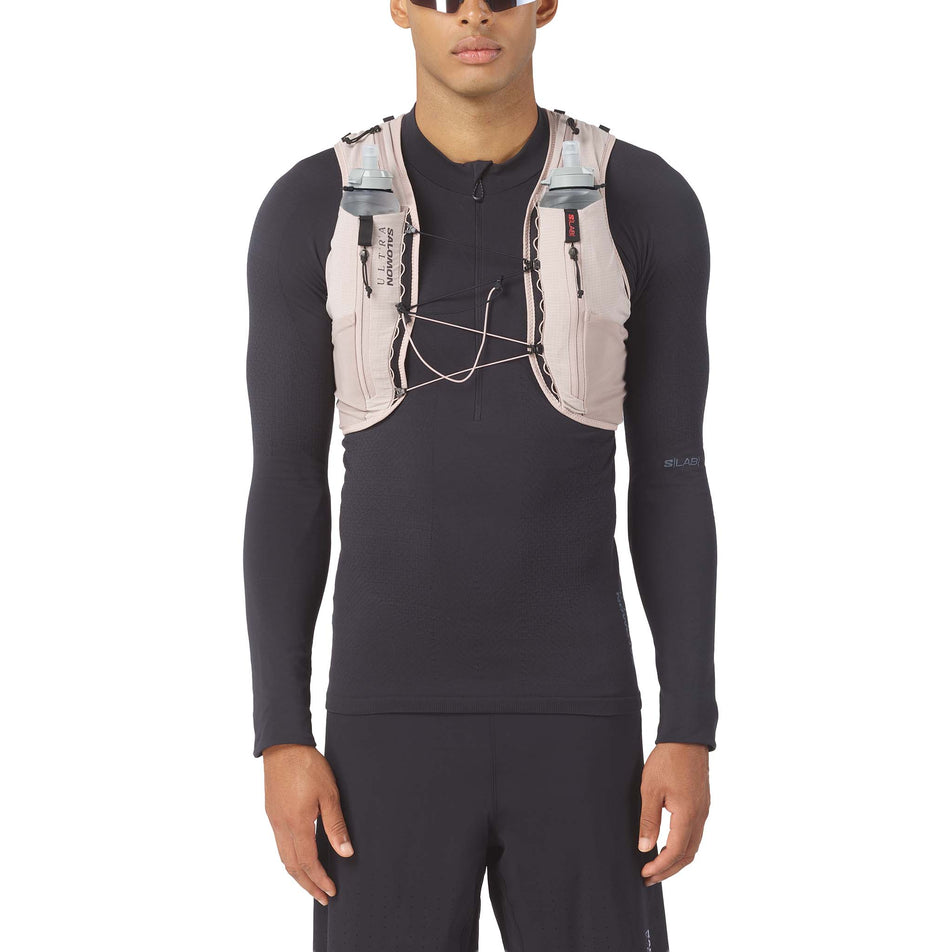 Front view of a model wearing the Salomon Unisex S/LAB Ultra 12 Running Vest in the Goat/Black colourway.