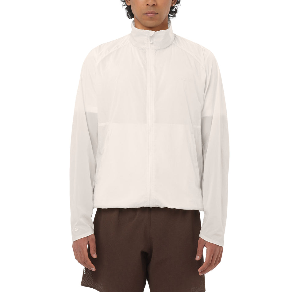 Front view of a model wearing the Salomon Men's SHKout Fly Jacket in the Whisper White colourway.