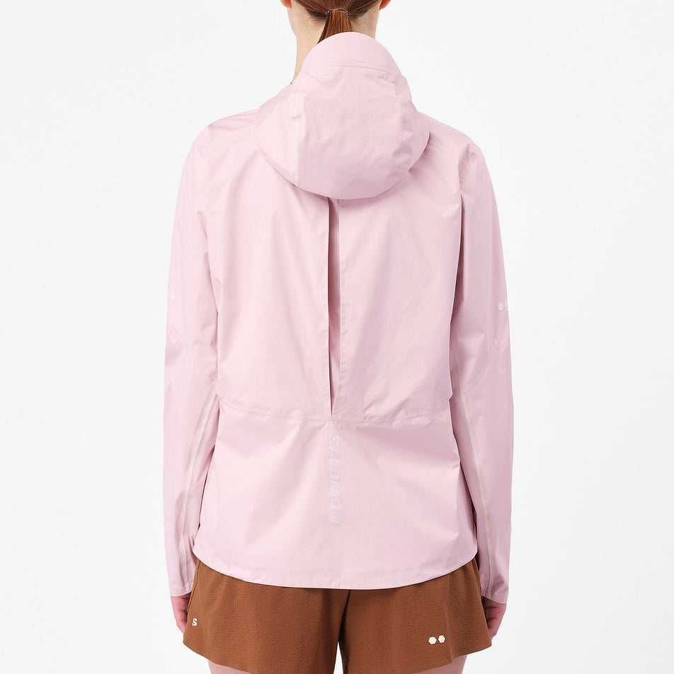Back view of a model wearing the Salomon Women's Bonatti Pro Shell Jacket in the Icy Pink colourway.