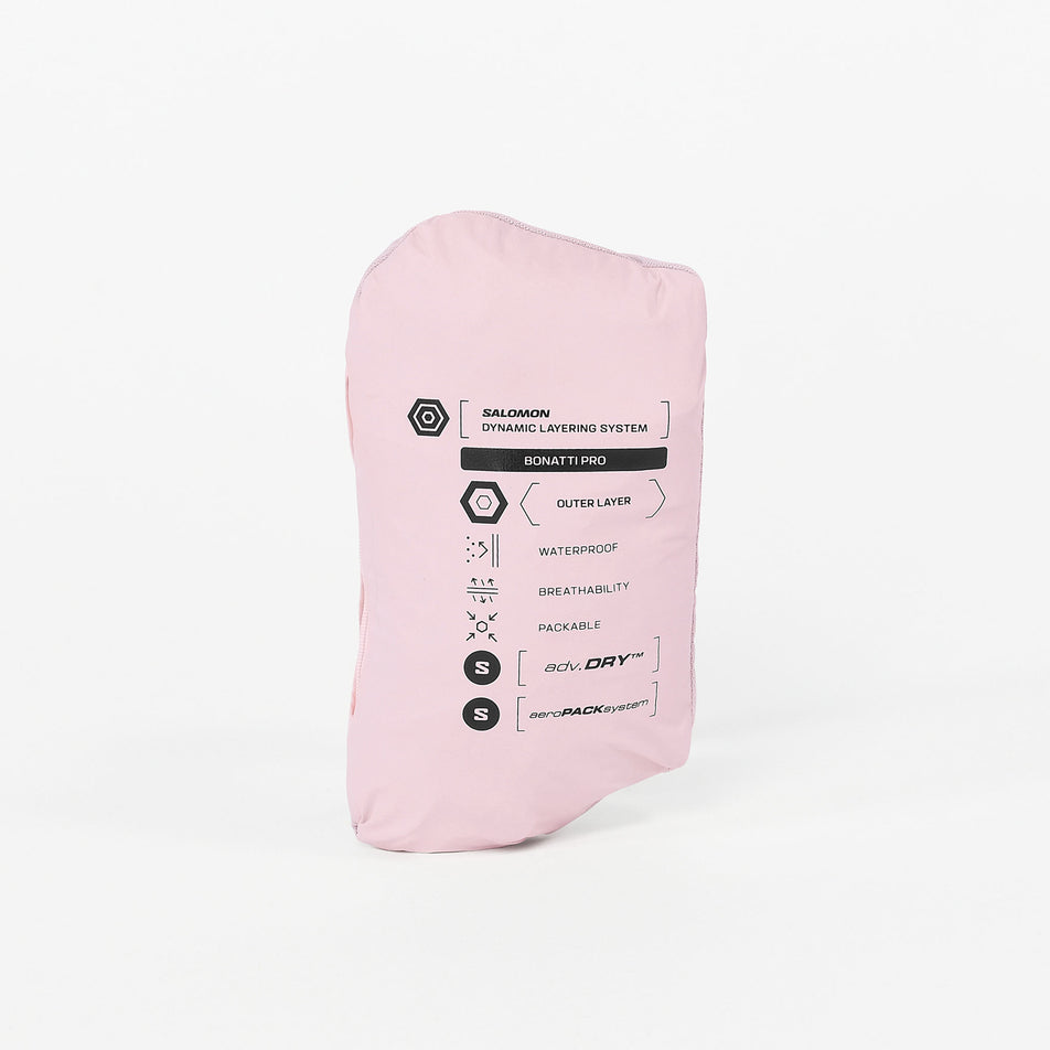The Salomon Women's Bonatti Pro Shell Jacket in the Icy Pink colourway stowed in its pocket.