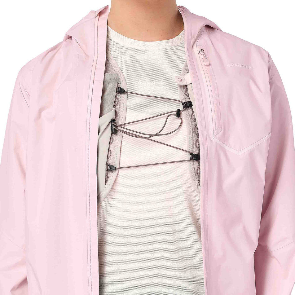 A hydration vest being worn underneath the Salomon Women's Bonatti Pro Shell Jacket in the Icy Pink colourway.