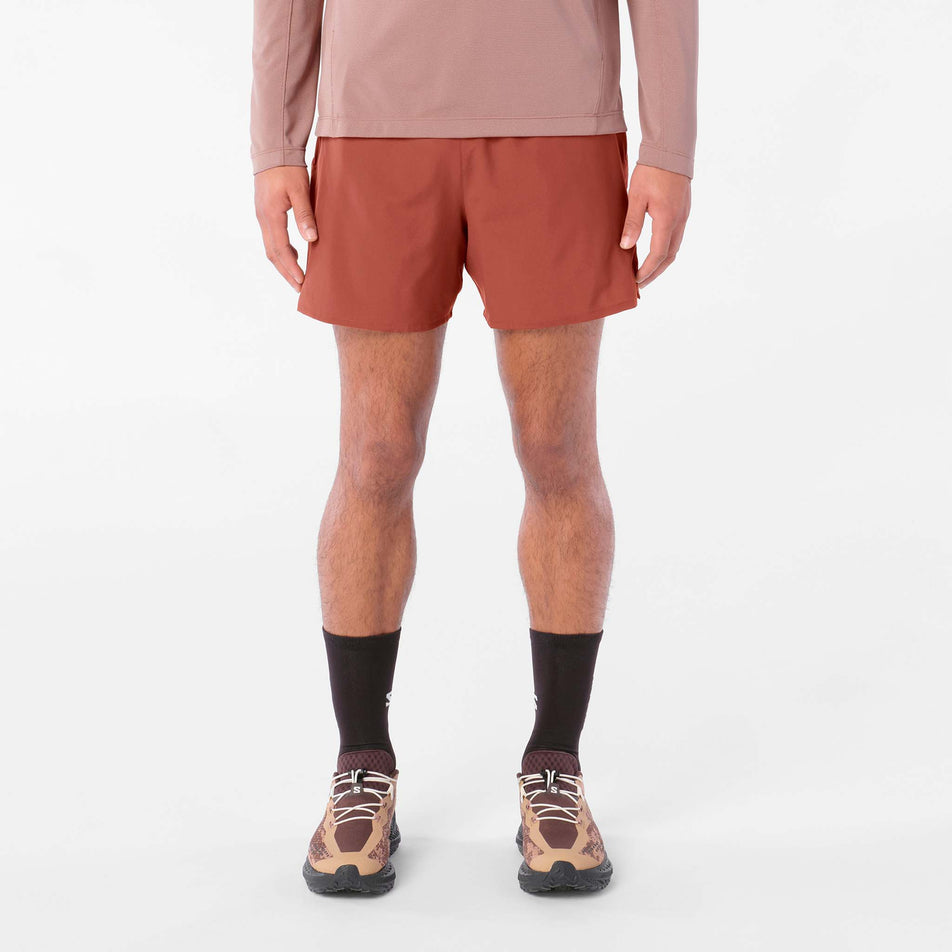 Front view of a model wearing the Salomon Men's Shakeout Core Shorts 5