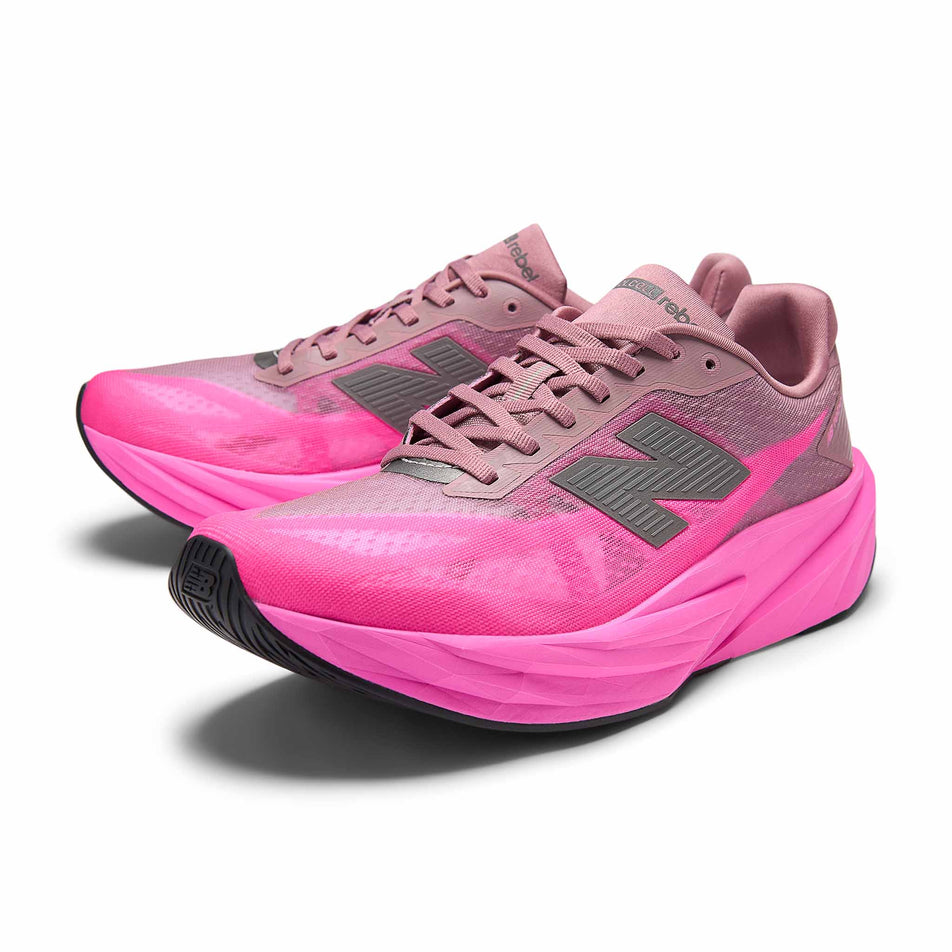 A pair of New Balance Men's Fuelcell Rebel V5 Running Shoes in the Pink Heat/Rosewood colourway.