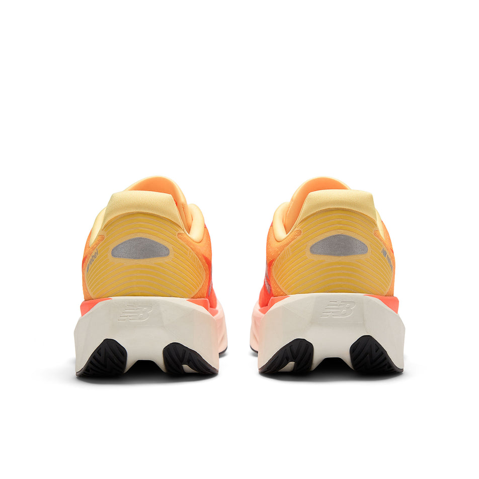 The back of a pair of New Balance Men's Fuelcell Rebel V5 Running Shoes in the Tangerine Heat colourway.