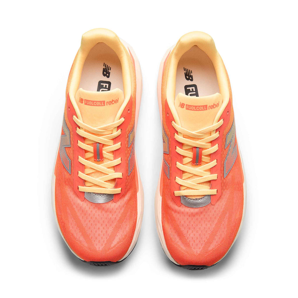 The uppers of pair of New Balance Men's Fuelcell Rebel V5 Running Shoes in the Tangerine Heat colourway.