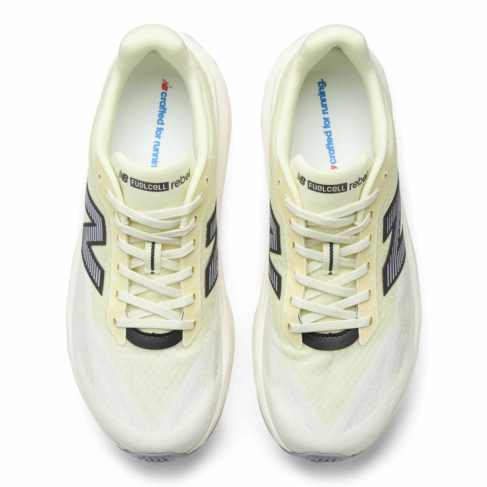 The uppers of a pair of New Balance Men's Fuelcell Rebel V5 Running Shoes in the Pistachio Butter/Digital Mist colourway.