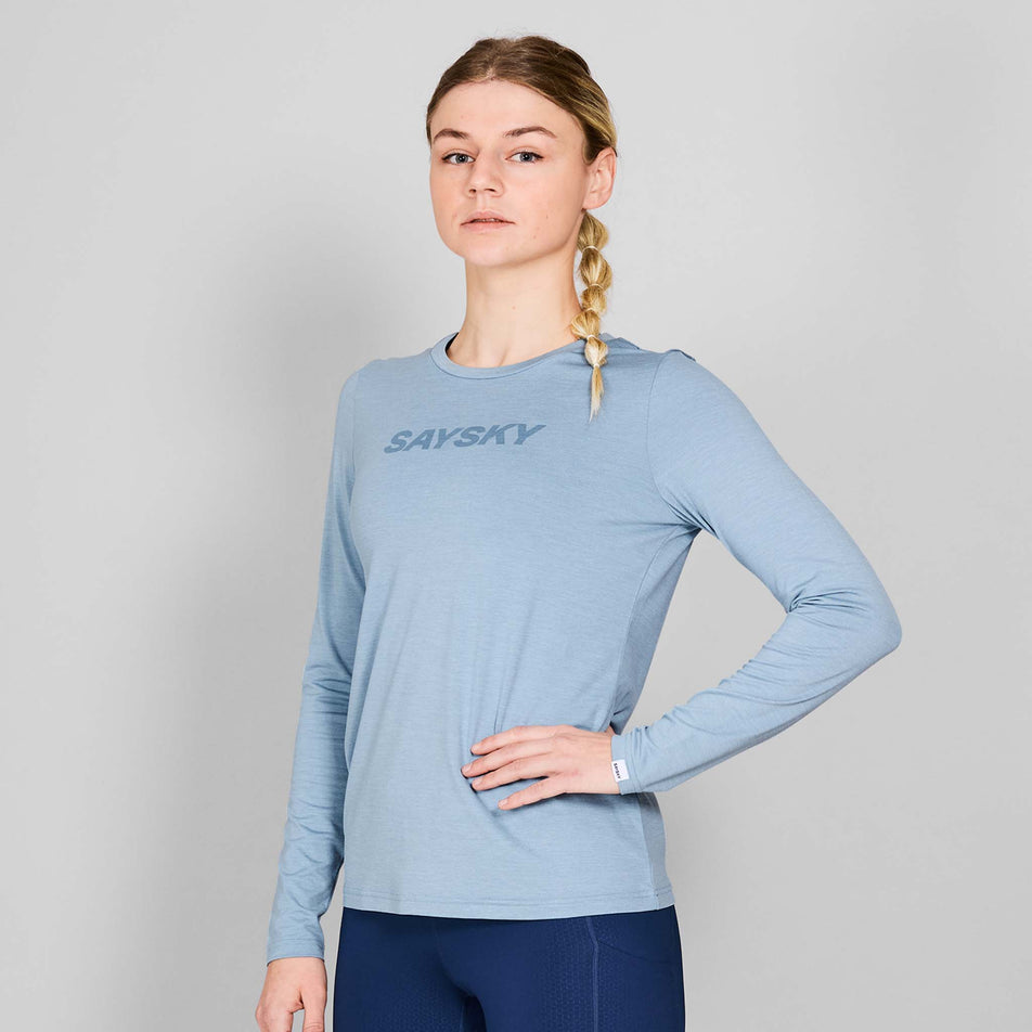 Front view of a model wearing the SAYSKY Women's Logo Pace Long Sleeve in the Blue Melange colourway. Model is also wearing tights. (8602010452130)