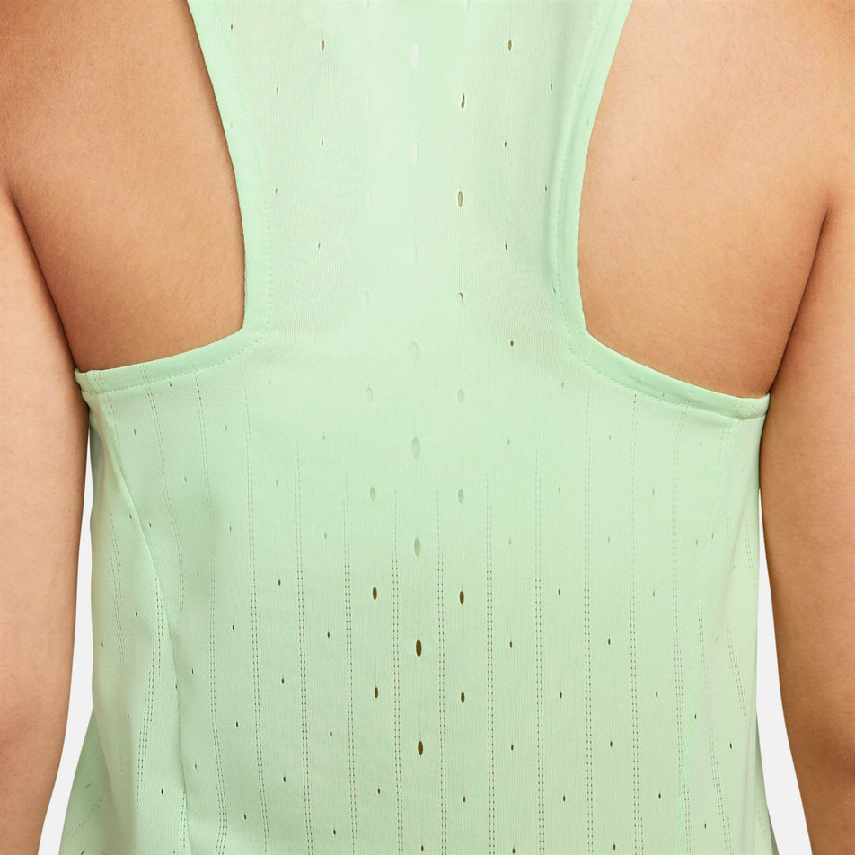 Close-up back view of a model wearing the Women's AeroSwift Dri-FIT ADV Running Singlet in the Vapor Green/Black colourway.  (8186003357858)